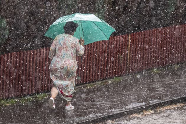 Heavy Rain in Göttingen, August 3, 2026, Göttingen: A pedestrian uses an umbrella to shield herself from the heavy rain in Göttingen, Göttingen, Lower Saxony, Germany