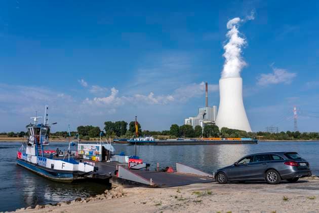 Extremely low water levels on the Rhine following the driest and warmest July on record; water levels have hit a record low; the riverbanks are exposed; shipping can only operate with reduced cargo and at reduced speeds; Duisburg Walsum, Ferry terminal for the car and passenger ferry from Orsoy to Walsum; STEAG Walsum Combined Heat and Power Plant; North Rhine