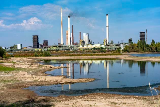 Extremely low water levels—here at the Thyssenkrupp Steel plant in Duisburg-Marxloh—have caused sandbars to form due to the low water level of the Rhine; cargo ships can only sail with reduced cargo; the TKS steel mill has cut back production because not enough raw materials can be d