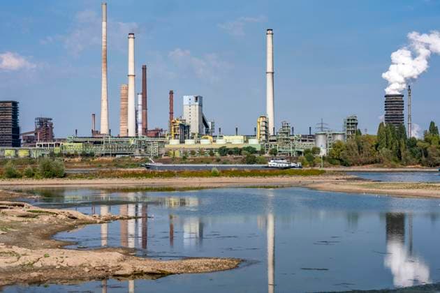 Extremely low water levels—here at the Thyssenkrupp Steel plant in Duisburg-Marxloh—have caused sandbars to form due to the low water level of the Rhine; cargo ships can only sail with reduced cargo; the TKS steel mill has cut back production because not enough raw materials can be d