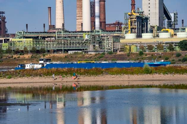 Extremely low water levels—here at the Thyssenkrupp Steel plant in Duisburg-Marxloh—have caused sandbars to form due to the low water level of the Rhine; cargo ships can only sail with reduced cargo; the TKS steel mill has cut back production because not enough raw materials can be d