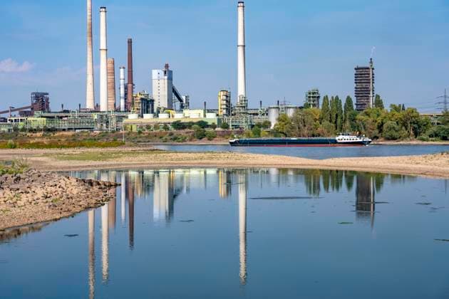Extremely low water levels—here at the Thyssenkrupp Steel plant in Duisburg-Marxloh—have caused sandbars to form due to the low water level of the Rhine; cargo ships can only sail with reduced cargo; the TKS steel mill has cut back production because not enough raw materials can be d