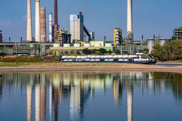 Extremely low water levels—here at the Thyssenkrupp Steel plant in Duisburg-Marxloh—have caused sandbars to form due to the low water level of the Rhine; cargo ships can only sail with reduced cargo; the TKS steel mill has cut back production because not enough raw materials can be d