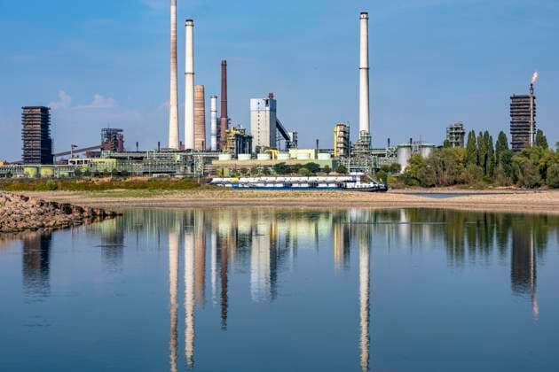 Extremely low water levels—here at the Thyssenkrupp Steel plant in Duisburg-Marxloh—have caused sandbars to form due to the low water level of the Rhine; cargo ships can only sail with reduced cargo; the TKS steel mill has cut back production because not enough raw materials can be d
