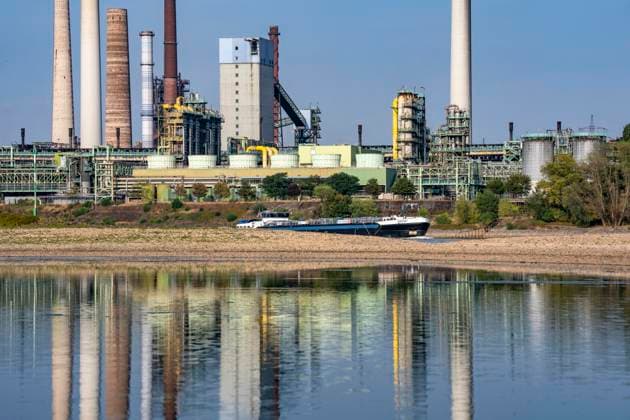 Extremely low water levels—here at the Thyssenkrupp Steel plant in Duisburg-Marxloh—have caused sandbars to form due to the low water level of the Rhine; cargo ships can only sail with reduced cargo; the TKS steel mill has cut back production because not enough raw materials can be d