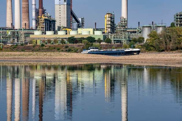 Extremely low water levels—here at the Thyssenkrupp Steel plant in Duisburg-Marxloh—have caused sandbars to form due to the low water level of the Rhine; cargo ships can only sail with reduced cargo; the TKS steel mill has cut back production because not enough raw materials can be d