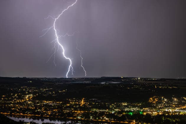 Lightning strike over the Rhine Valley near Bad Godesberg and Wachtberg; view from Petersberg in the Siebengebirge range looking west; a bolt of lightning strikes near a thunderstorm front; in the foreground, the Rhine and the towns of Bonn, Mehlem, Bad Godesberg, and Wachtberg; clearly visible is the radome of the Fraunhofer Ins Copyright: xMarcxJohnx