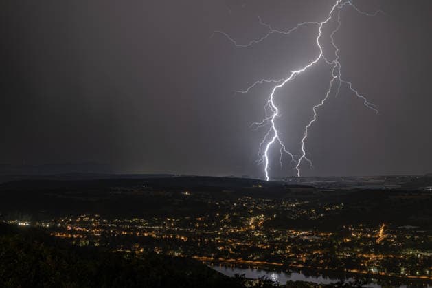 Lightning striking over the Rhine Valley near Bad Godesberg and Wachtberg; view from Petersberg in the Siebengebirge range looking west; several bolts of lightning strike as a thunderstorm front passes; in the foreground, the Rhine and the towns of Bonn, Mehlem, Bad Godesberg, and Wachtberg; Königswinter, North Rhine-Westphalia, Germany Copyright: xMarcxJohnx