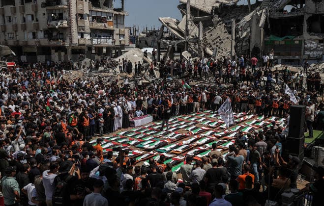 Palestinians mourn 112 people retrieved from rubble in Gaza GAZA, PALESTINE - AUGUST 04: An aerial view of Palestinians taking part in a funeral for 112 Palestinians in Gaza, Palestine, on August 04, 2026. The 112 Palestinians were killed in Israeli attacks targeting the area where the Hasayine and Abu Sharia families lived in the Sabra neighborhood of Gaza City in November 2023, and their bodies were retrieved from the rubble nearly three years later. Ali Jadallah Anadolu Gaza Palestine. Editorial use only. Please get in touch for any other usage.  Copyright: x2026xAnadoluxAlixJadallahx