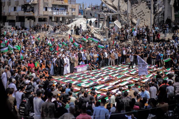 Palestinians Hold Mass Funeral For 112 Family Members In Gaza - Palestine A photograph shows the flag-covered remains of members of the Abu Sharia and al-Hasayna families, recently recovered from the rubble of residential buildings in the al-Sabra neighbourhood which were struck by Israeli bombardments in November 2023, during a mass funeral in Gaza City on August 4, 2026. An October ceasefire remains in place between Israel and Hamas, but it has not halted the violence in Gaza. Photo by Photo by Rizek ELdremle ABACAPRESS.COM Gaza City Palestine  Copyright: xEldremlexRizek ABACAx