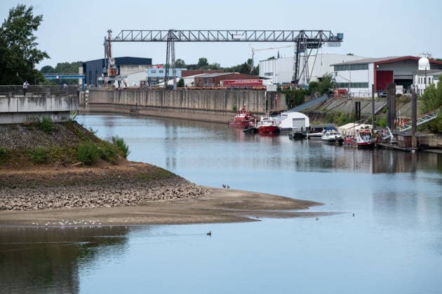 Historically low water levels on the Rhine; the Düsseldorf Water Police report that the Rhine’s water level in Düsseldorf has reached 23 cm, the lowest ever recorded there. The low water level has exposed a sandbar; in the background is the entrance to the harbor basins, Düsseldorf, August 4, 2026