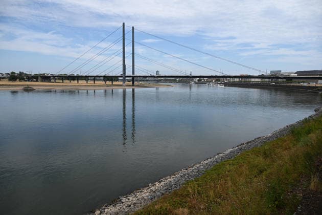 Historically low water levels on the Rhine; the Düsseldorf Water Police report that the Rhine’s water level in Düsseldorf has reached 23 cm—the lowest ever recorded there. Low water level, rocky riverbank, with the Rheinknie Bridge in the background, Düsseldorf, August 4, 2026
