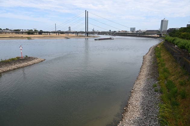 Record-low water levels on the Rhine; the Düsseldorf Water Police report that the Rhine’s water level in Düsseldorf has reached 23 cm—the lowest ever recorded there. View toward the Old Town, with the Rheinknie Bridge in the background and the entrance to the harbor basins in the foreground, Düsseldorf, August 4, 2026