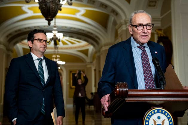 Sen. Brian Schatz, D-HI, looks on as Senate Minority Leader Chuck Schumer, D-NY, speaks during a press conference after weekly Senate caucus luncheons at the U.S. Capitol in Washington, DC on Tuesday, August 4, 2026. With August recess approaching, Senate Democrats are looking to pass a budget bill to prevent a shutdown before the midterms.  WAP20260804360 BONNIExCASH