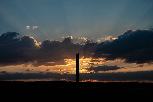 The sun sets behind the TK Elevator test tower in Rottweil. The test tower can be seen as a silhouette against the evening sky. Rottweil, Baden-Württemberg, Germany