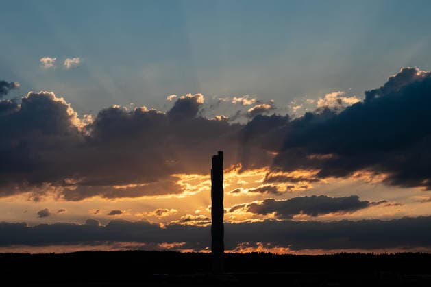 The sun sets behind the TK Elevator test tower in Rottweil. The test tower can be seen as a silhouette against the evening sky. Rottweil, Baden-Württemberg, Germany