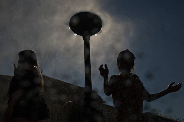 Krakow Hits 39Â°C As Severe Heatwave Triggers Red Weather Alerts Across Poland KRAKOW, POLAND - AUGUST 5: Framed through a water-spattered camera lens, children are cast in deep silhouette as they dance in the spray of a municipal cooling post in the Main Market Square during a severe heatwave on August 5, 2026, in Krakow, Poland. The Institute of Meteorology and Water Management (IMGW) sustained its critical third-degree red alert across southern Poland as ambient temperatures reached a punishing peak of 39Â°C (102.2Â°F). Krakow Poland  Copyright: xArturxWidakx originalFilename: widak-krakowhi260805_npE97.jpg