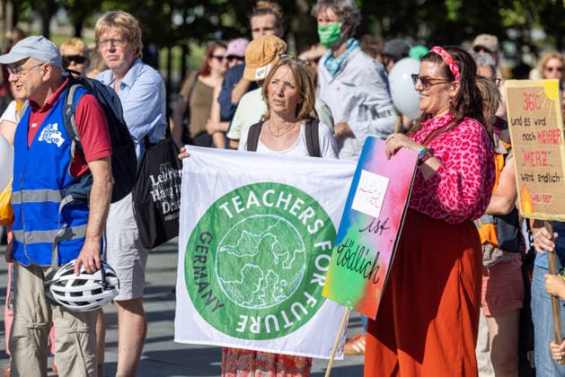 Fridays for Future Berlin Heat Protest, Germany, Berlin, August 6, 2026. Climate activists are protesting in front of the Chancellery under the slogan The Climate Crisis Is Escalating, Chancellor Remains Silent. They are demanding stronger climate protection measures, rapid political action to combat the heat, and a consistent