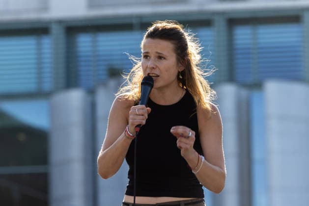 Fridays for Future Berlin Heat Protest, Germany, Berlin, August 6, 2026. Luisa Neubauer addresses the protesters from the stage in front of the Chancellery. In front of the Chancellery, climate activists are protesting under the slogan The Climate Crisis Is Escalating, Chancellor Remains