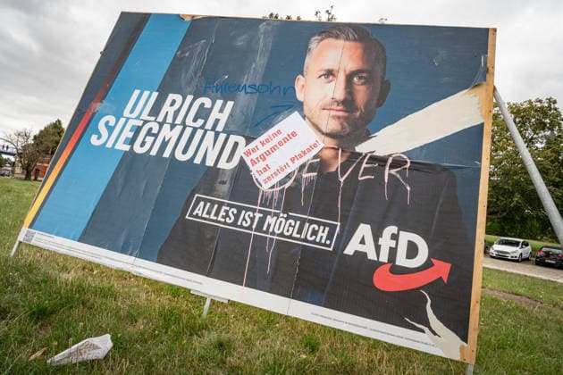 Damaged AfD campaign poster featuring lead candidate Ulrich Siegmund; campaign poster for the 2026 state election in Magdeburg, Saxony-Anhalt, Magdeburg, Saxony-Anhalt, Germany; downtown Magdeburg