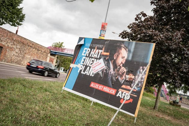 Damaged AfD campaign poster featuring lead candidate Ulrich Siegmund; poster for the 2026 state election in Magdeburg, Saxony-Anhalt, Magdeburg, Saxony-Anhalt, Germany; downtown Magdeburg