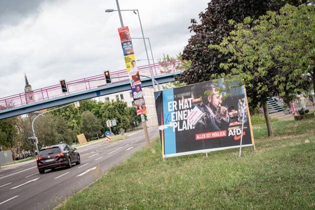 Damaged AfD campaign poster featuring lead candidate Ulrich Siegmund; poster for the 2026 state election in Magdeburg, Saxony-Anhalt, Magdeburg, Saxony-Anhalt, Germany; downtown Magdeburg