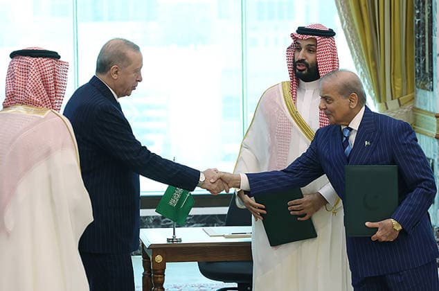 Turkish President Recep Tayyip Erdogan (L), Saudi Crown Prince Mohammed bin Salman (C), and Pakistani Prime Minister Shehbaz Sharif (R) sign a trilateral defense agreement in Mecca, Saudi Arabia, on Friday on August 7, 2026.  SAU2026080712 TurkishxPresidencyxOffice