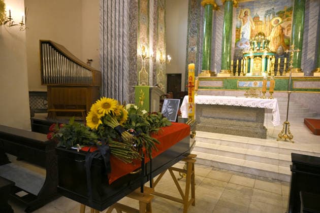 Flowers lay on the coffin of Polish volunteer Marek Rusek-Wolski, who was killed near Kharkiv by a Russian drone attack, during the farewell ceremony at the Cathedral of St Alexander in Kyiv, Ukraine, August 7, 2026. The tragedy occurred at the end of July (approximately 27 July) near Kharkiv, when the volunteer came under a targeted Russian drone strike while on a humanitarian mission. Marek Rusek-Wolski was an administrator of the Polish volunteer community Razem dla Ukrainy. Since early 2023, he had been regularly travelling to Ukraine. He used to organise fundraisers, purchase and deliver food, medicines, hygiene products and animal feed to the most dangerous front-line settlements in the Kharkiv region. (Photo by Yevhen Kotenko Ukrinfo Copyright: xYevhenxKotenkox