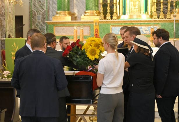 People lay flowers on the coffin of Polish volunteer Marek Rusek-Wolski, who was killed near Kharkiv by a Russian drone attack, during the farewell ceremony at the Cathedral of St Alexander in Kyiv, Ukraine, August 7, 2026. The tragedy occurred at the end of July (approximately 27 July) near Kharkiv, when the volunteer came under a targeted Russian drone strike while on a humanitarian mission. Marek Rusek-Wolski was an administrator of the Polish volunteer community Razem dla Ukrainy. Since early 2023, he had been regularly travelling to Ukraine. He used to organise fundraisers, purchase and deliver food, medicines, hygiene products and animal feed to the most dangerous front-line settlements in the Kharkiv region. (Photo by Yevhen Kotenko Copyright: xYevhenxKotenkox