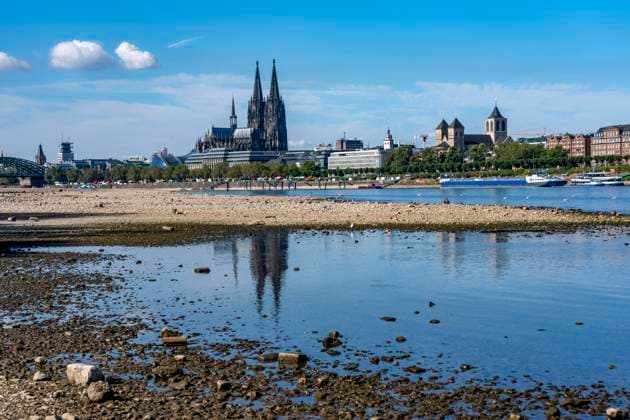 Low water levels in the Rhine near Cologne, View looking south from the right bank of the Rhine at Rheinpark; the city center with the cathedral; inland waterway shipping is severely restricted, with only a few ships operating, and those carrying greatly reduced loads; on the day this photo was taken, the Rhine water level in Cologne was the lowest ever recorded to date, at 60 cm, No