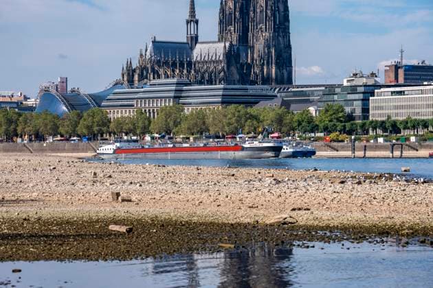 Low water levels in the Rhine near Cologne, View looking south from the right bank of the Rhine at Rheinpark; the city center with the cathedral; inland waterway shipping is severely restricted, with only a few ships operating, and those carrying greatly reduced loads; on the day this photo was taken, the Rhine water level in Cologne was the lowest ever recorded to date, at 60 cm, No