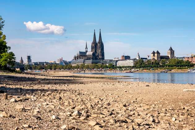 Low water levels in the Rhine near Cologne, View looking south from the right bank of the Rhine at Rheinpark; the city center with the cathedral; inland waterway shipping is severely restricted, with only a few ships operating, and those carrying greatly reduced loads; on the day this photo was taken, the Rhine water level in Cologne was the lowest ever recorded to date, at 60 cm, No