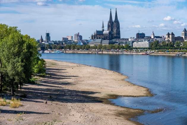 Low water levels in the Rhine near Cologne, View looking south from the right bank of the Rhine at Rheinpark; the city center with the cathedral; inland waterway shipping is severely restricted, with only a few ships operating, and those carrying greatly reduced loads; on the day this photo was taken, the Rhine water level in Cologne was the lowest ever recorded to date, at 60 cm, No