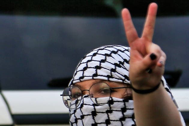 August 7, 2026, Beirut, Beirut, Lebanon: A Lebanese activist, covering her face with the traditional Palestinian keffiyeh scarf , flashes the Ã¢â‚¬ËœÃ¢â‚¬â ¢VÃ¢â‚¬â ¢Ã¢â‚¬â ¢ sign during a protest in Beirut against Lebanon-Israeli direct talks and the normalization of relation with the Jewish state. Lebanon and Israel have held their first diplomatic talks in over three decades, a rare encounter aimed at ending fighting between Israel and the Iran-backed Hezbollah group. Several Lebanese political organizations and groups, led by Hezbollah, have opposed the talks. Beirut Lebanon - ZUMAn313 20260807_zip_n313_003 Copyright: xMarwanxNaamanix