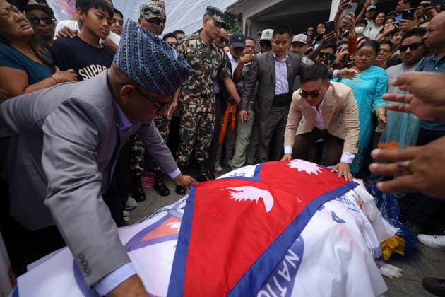 Funeral Held For Record Holding Nepali Climber Pur Bahadur Gurung- -Yukta- Killed In Broad Peak Avalanche With Honors Nepali Home Minister Sudhan Gurung, wearing glasses, drapes the body of Nepali mountaineer Pur Bahadur Gurung (Yukta) with Nepal s national flag ahead of his funeral in Kathmandu, Nepal, on August 7, 2026. Pur Bahadur Gurung died during an expedition on Pakistan s 8,047-metre Broad Peak in July 2026. The cremation took place at Swayambhu in the presence of family members, relatives, Home Minister Sudhan Gurung, Nepali Congress President Gagan Thapa, members of the mountaineering community and well-wishers. The funeral was led by shamans who performed rituals after circumnavigating the Swayambhunath Stupa, a UNESCO World Heri Copyright: xSubaasxShresthax originalFilename: shrestha-funeralh260807_npamh.jpg