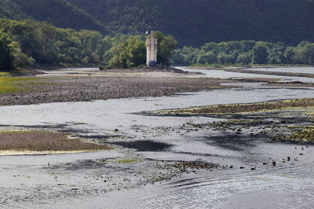 August 7, 2026, Bingen, Germany: Low water on the Rhine as seen from Bingen. In the center is the Maeuseturm on a small island, which is normally accessible only by boat.