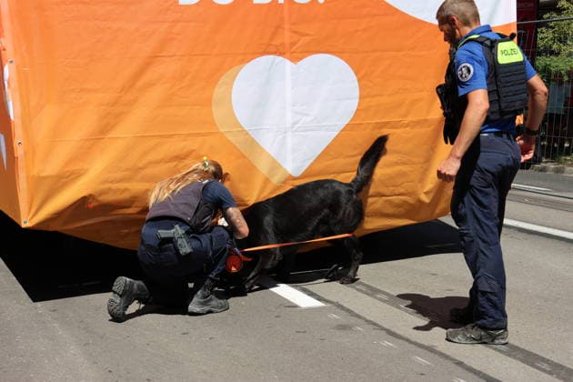 August 8, 2026, Zurich, Switzerland: A photo from the 33rd Street Parade showing a Love Mobile music truck being inspected by a police dog trained to detect drugs and explosives