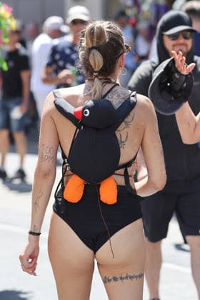 August 8, 2026, Zurich, SWITZERLAND, 33rd Zurich Street Parade participant with a penguin backpack