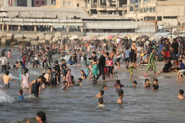 Palestinian families seek respite from summer heat on Gaza beach Palestinian families gather on the beach in Gaza City to escape the summer heat and spend time by the sea, as tents sheltering displaced Palestinians line the coast, on August 8, 2026. Residents seek moments of rest amid difficult living conditions caused by the war. Photo by Bilal Osama apaimages Gaza city Gaza Strip Palestinian Territory 080826_Gaza_BO_02(45) Copyright: xapaimagesxBilalxOsamax xapaimagesx