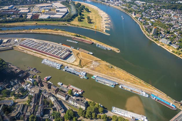 Aerial view, cargo ships docked at the exit of the Port of Duisburg, historic low water levels on the Rhine, Kaßlerfeld, Duisburg, Ruhr region, North Rhine-Westphalia, Germany ATTENTION: MINIMUM FEE: 60 EUR