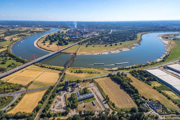 Aerial view, railroad bridge and A42 highway bridge toward Bruckhausen, historic low water level on the Rhine, Beeckerwerth, Duisburg, Ruhr region, North Rhine-Westphalia, Germany ATTENTION: MINIMUM FEE: 60 EUR