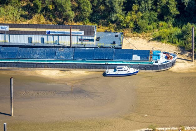 Aerial view, cargo ship stranded in the harbor of Spijk and Tolkamer in the Netherlands; historic low water levels on the Rhine; Salmorth, Kleve, Ruhr region, North Rhine-Westphalia, Germany ATTENTION: MINIMUM FEE: 60 EUR