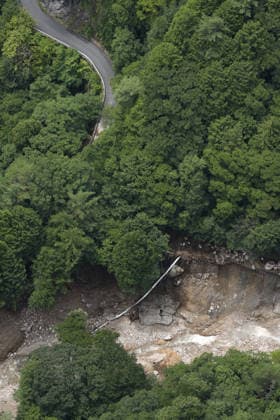 Landslide in central Japan Photo taken from a Kyodo News helicopter on Aug. 9, 2026, shows the site of a landslide in Azumino in Nagano Prefecture, central Japan. The landslide occurred on the night of Aug. 8, cutting off the only road leading to a nearby hot spring mountain resort and leaving about 390 people there stranded.  A14AA0005625429P