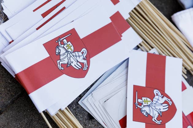 August 9, 2026, Warsaw, Poland: Belarusian national white-red-white flags and Pahonia emblems are sold during an evening rally marking the sixth anniversary of the August 2020 presidential election in Belarus in central Warsaw. An evening gathering marking the sixth anniversary of the August 2020 presidential election in Belarus was held near the Nicolaus Copernicus Monument in central Warsaw, bringing together leaders of Belarusian democratic forces, public figures and activists, as well as several hundred participants. Warsaw Poland  - ZUMAs197 20260809_aaa_s197_104 Copyright: xVolhaxShukailax