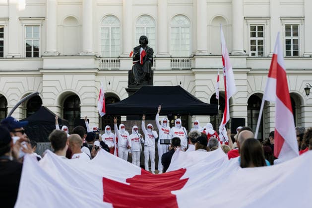 August 9, 2026, Warsaw, Poland: Members of the Volny Chor, whose identities are concealed for security reasons, perform during an evening rally marking the sixth anniversary of the August 2020 presidential election in Belarus. An evening gathering marking the sixth anniversary of the August 2020 presidential election in Belarus was held near the Nicolaus Copernicus Monument in central Warsaw, bringing together leaders of Belarusian democratic forces, public figures and activists, as well as several hundred participants. Warsaw Poland  - ZUMAs197 20260809_aaa_s197_109 Copyright: xVolhaxShukailax