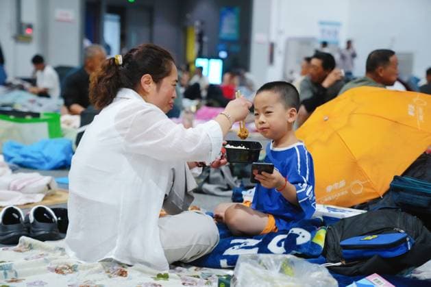 HANGZHOU, CHINA - AUGUST 09: A temporary shelter is set up for workers at Qianjiang Century City on August 9, 2026 in Hangzhou, Zhejiang Province of China. Nearly 10,000 workers were safely evacuated from the area as Typhoon Dolphin approaches.  Copyright: xVCGx 111658991064