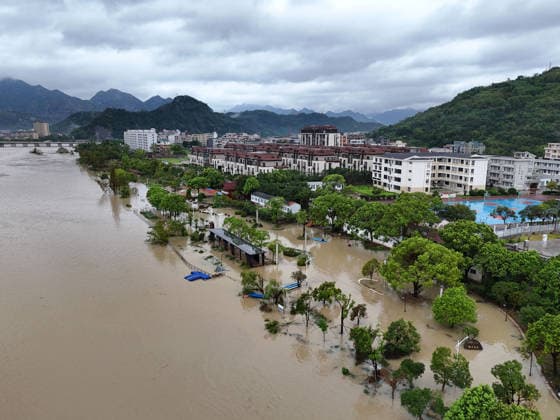 YUEQING, CHINA - AUGUST 10: Floodwaters flow in a local stream as residents work to restore the area following Typhoon Dolphin on August 10, 2026 in Yueqing, Zhejiang Province of China. The typhoon brought heavy rainfall and strong winds to the region, causing flooding and disruption.  Copyright: xVCGx 111659089569