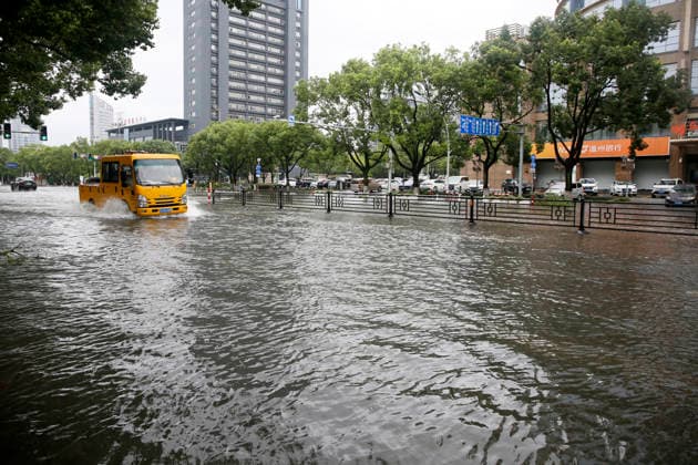 WENLING, CHINA - AUGUST 10: A vehicle drives through flooded street on August 10, 2026 in Wenling, Zhejiang Province of China. Heavy rainfall brought by Typhoon Dolphin caused severe waterlogging on roads and affecting residents travel. Typhoon Dolphin, the 13th typhoon of the year, made landfall at Yuhuan of Taizhou City, east China s Zhejiang Province, at around 5:30 p.m. on August 9.  Copyright: xVCGx 111659097426