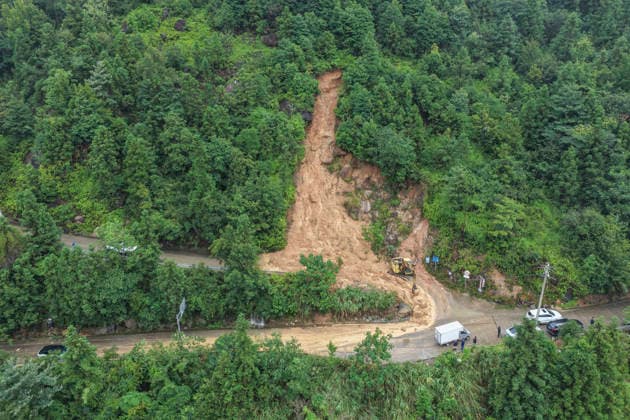 WENZHOU, CHINA - AUGUST 09: Excavators clear landslide debris to reopen a blocked village road on August 9, 2026 Wenzhou, Zhejiang Province of China. Strong winds up to level 15 (46.2 to 50.9 meters per second) have ripped through Yueqing City in east China s Zhejiang Province since Typhoon Dolphin made landfall in the region on Sunday, with hundreds of toppled trees and broken branches blocking roads across the city.  Copyright: xVCGx 111659124823