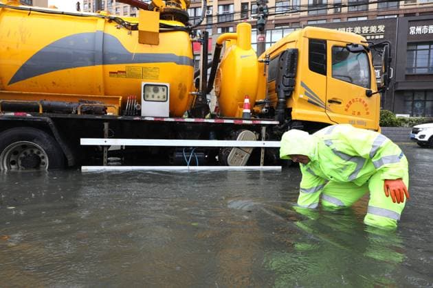 (260810) -- BEIJING, Aug. 10, 2026 -- A rescue worker works on a waterlogged road in Changzhou, east China s Jiangsu Province, Aug. 10, 2026. Typhoon Dolphin is moving inland after making two landfalls along the coast of east China s Zhejiang Province and is expected to bring heavy precipitation to more than 10 provincial-level regions, according to China s National Meteorological Center on Monday. The center issued a blue typhoon warning on Monday morning, forecasting persistent heavy rainfall through Wednesday in regions including Zhejiang, Jiangsu, Henan and Hebei. Some areas are likely to experience torrential rain, thunderstorms and strong winds. Authorities in multiple localities have made all-out efforts in flood prevention an